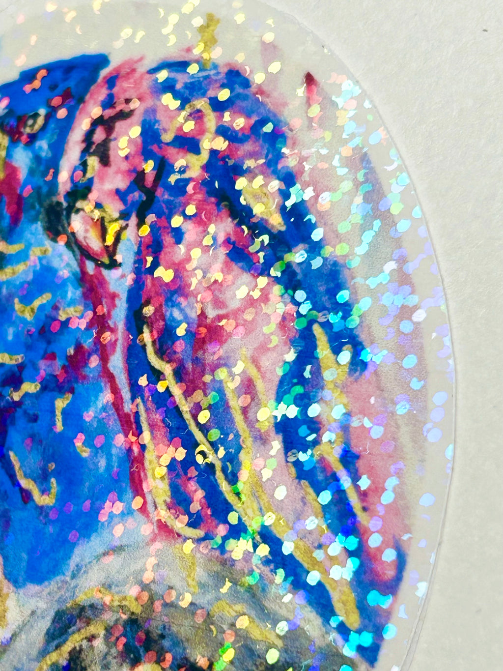 Close-up of Starwoven sticker showing the pink bird and colorful holographic shimmer