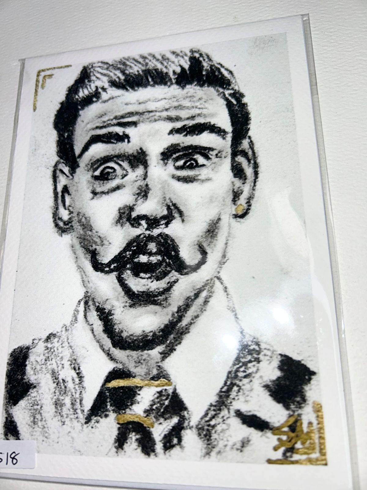 Close-up of The Showman portrait art print featuring an expressive black and white male portrait with gold accents.