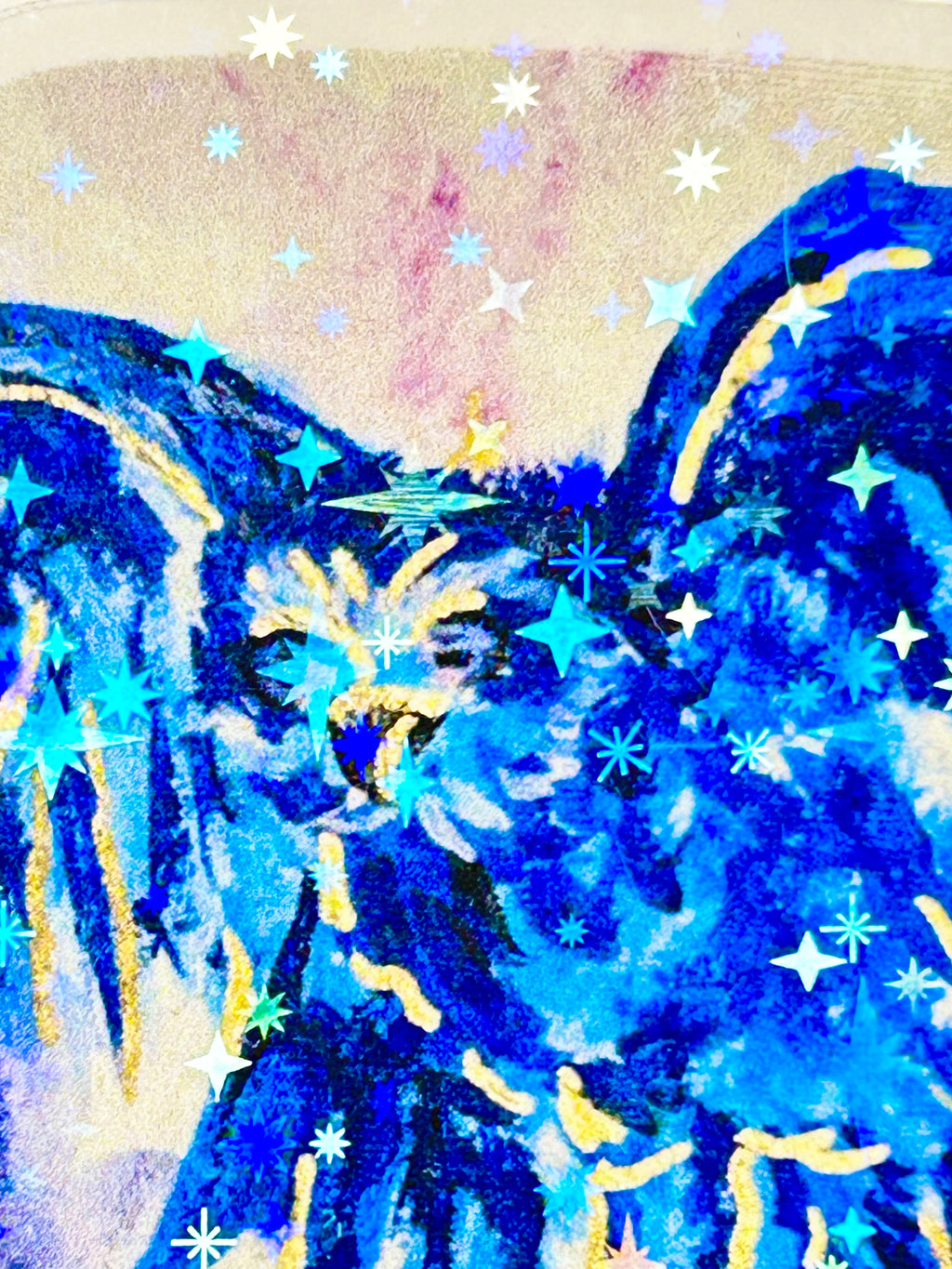 Close-up of Voiding Radiance laminated vinyl sticker featuring a vivid blue bird with gold details and holographic star accents.