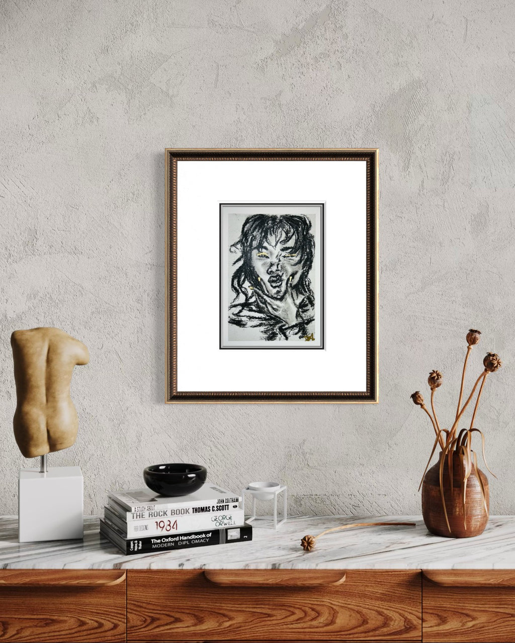 Wild Spark charcoal fine art print with gold accents displayed in a frame on a styled interior wall.