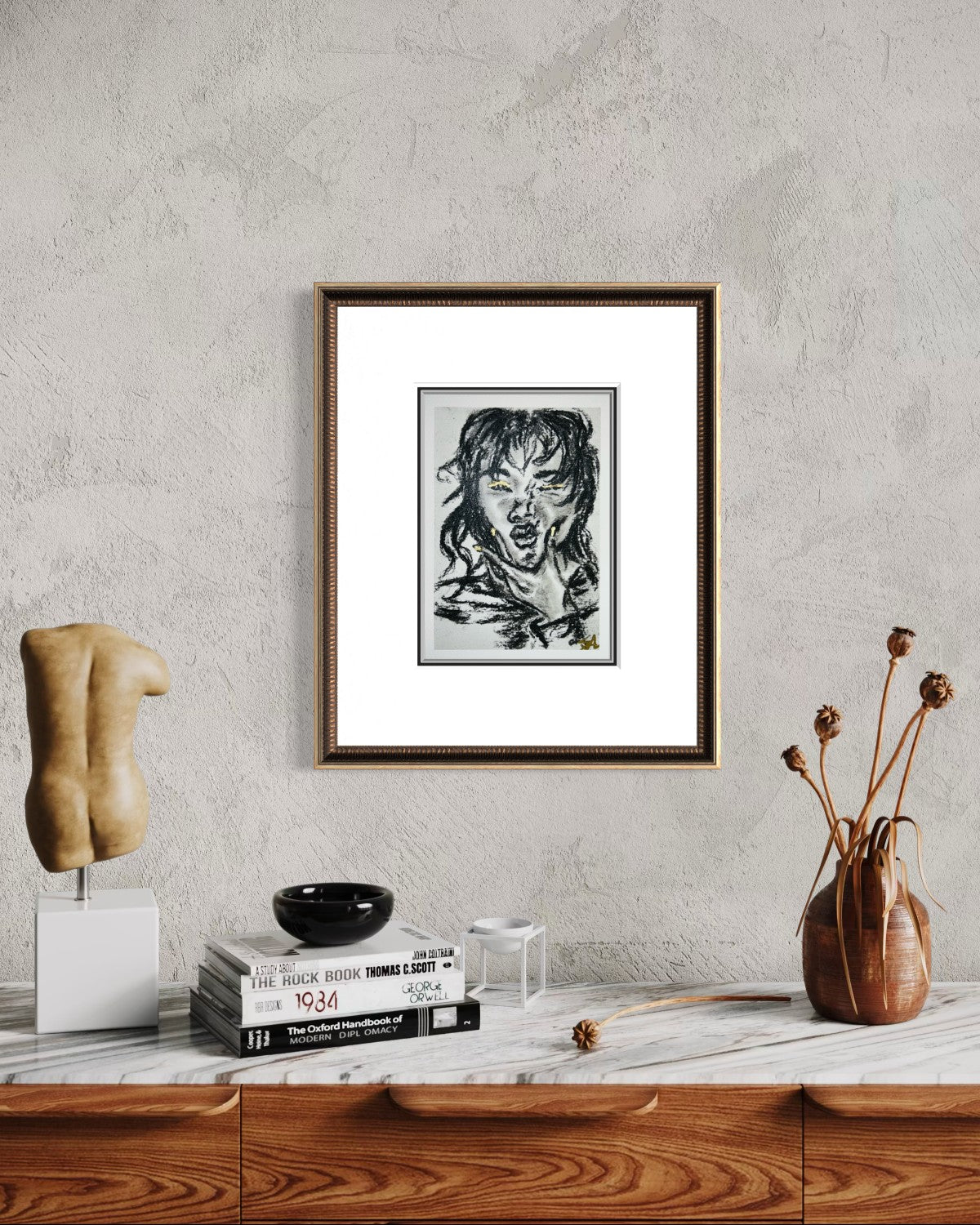 Wild Spark charcoal fine art print with gold accents displayed in a frame on a styled interior wall.